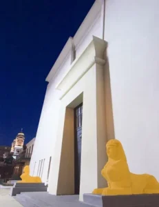 A building with yellow statues on the front of it.